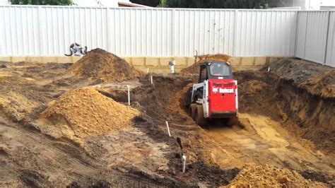 digging pool with skid steer|how to dig a pool.